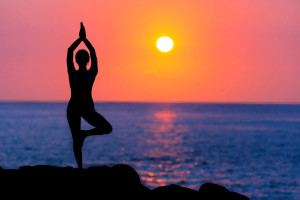 woman-doing-yoga-at-sunset